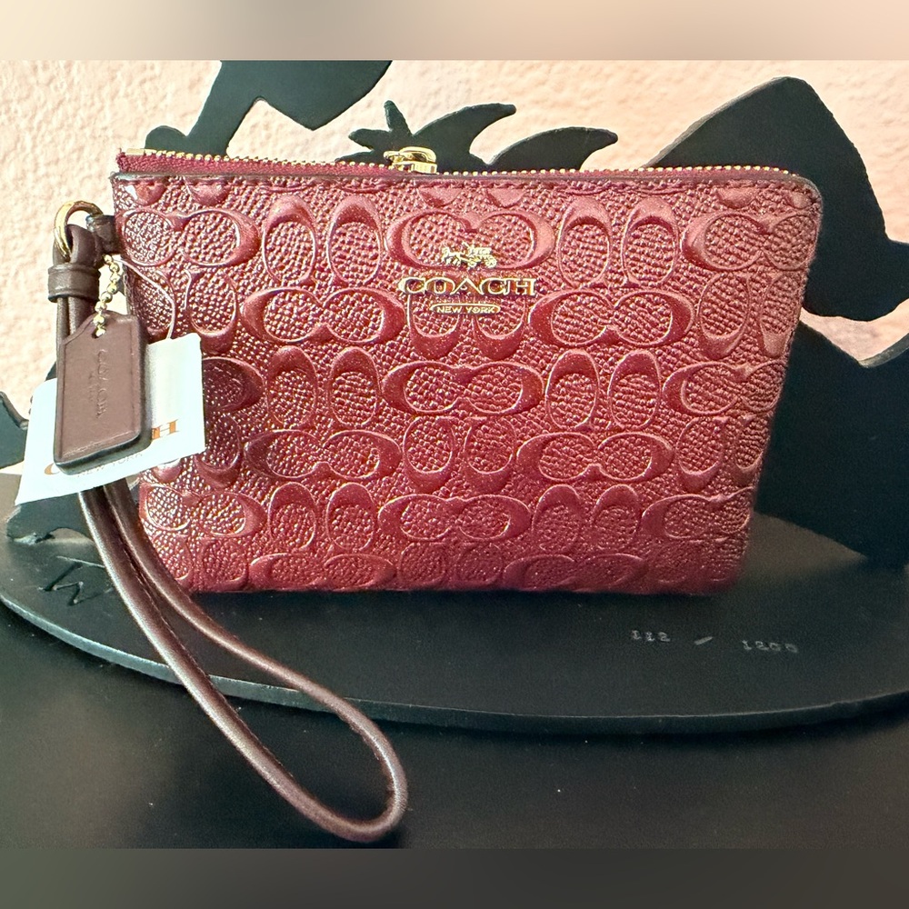 NWT. Coach Embossed Signature Wristlet in Burgundy.